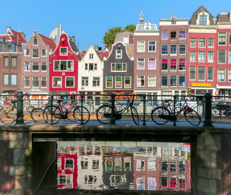 Student travelers park bicycles on the bridge in the city of Amsterdam, Netherlands.