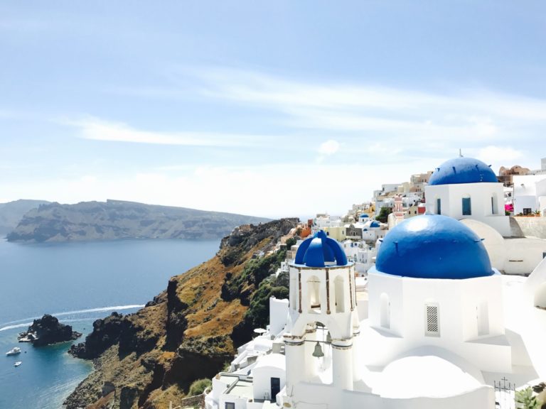 Student travelers take a tour of the blue buildings in Blue Buildings on the island of Oia, Santorini Greece.