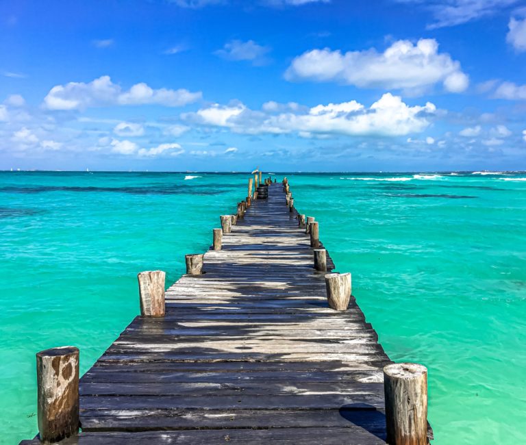 A tour of a dock to the brilliant blue ocean in Cancun, Mexico travel.