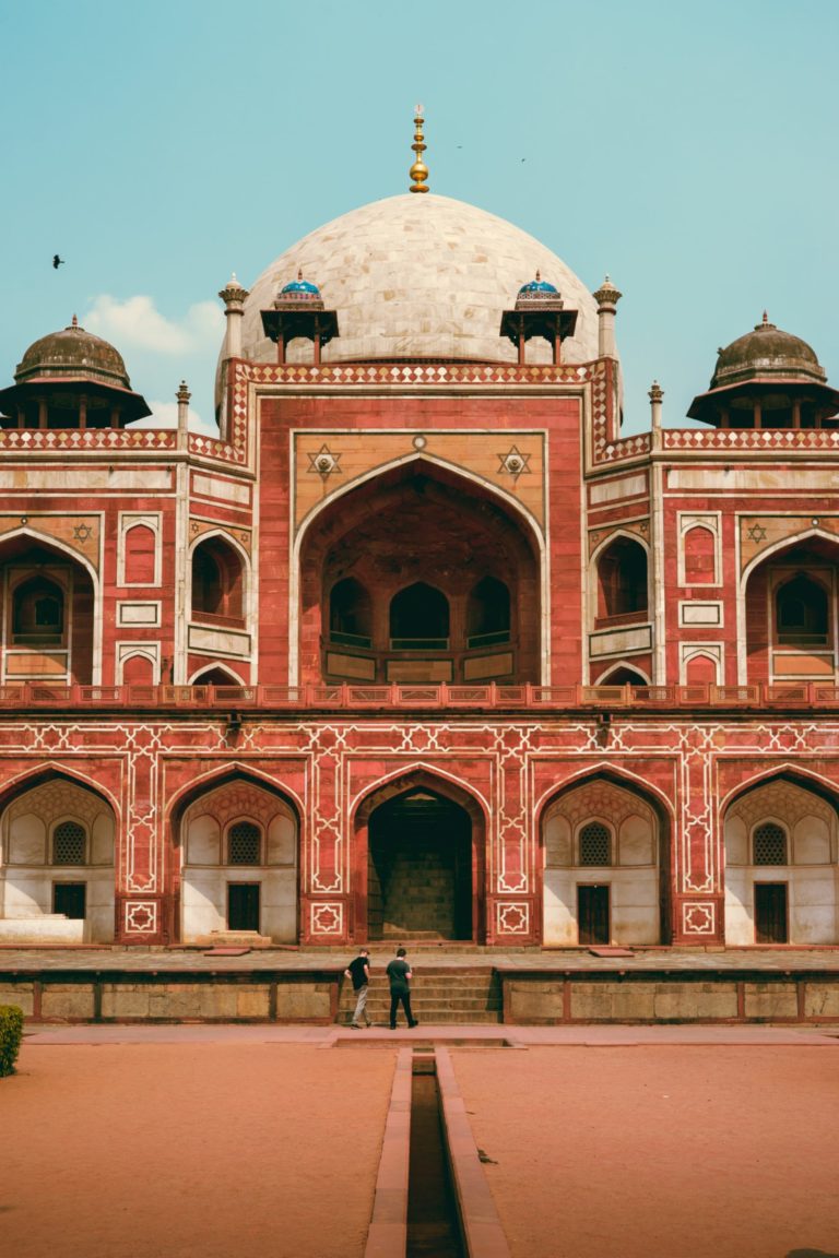 Two student travelers touring the exterior of Humayun's Tomb in New Delhi, India.