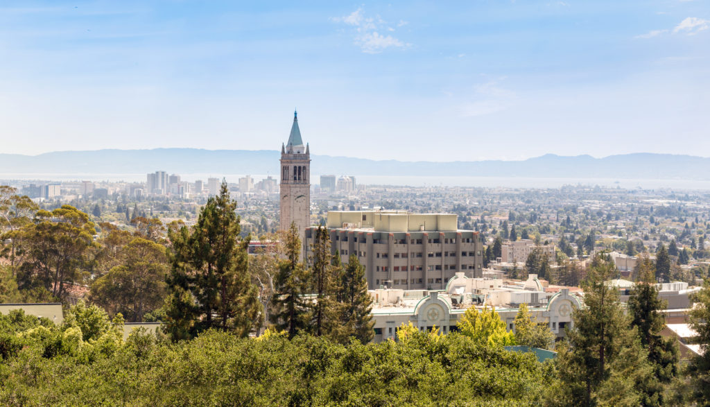 The clocktower of Berkeley University is above the skyline of the gorgeous modern city that students love. This image is featured in the Students Fare student travel blog, "Best College Towns in America," which describes the top university cities in the USA.