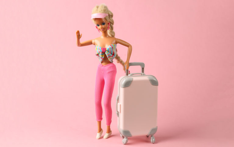Featured in Barbie Film Locations by Students Fare, this image of the Barbie doll in fur coat and shoes with luggage