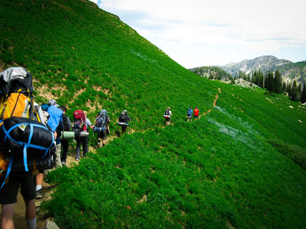 Featured in Backpacking Guide for Students by Students Fare, this image shows a group of young hikers on a hike.