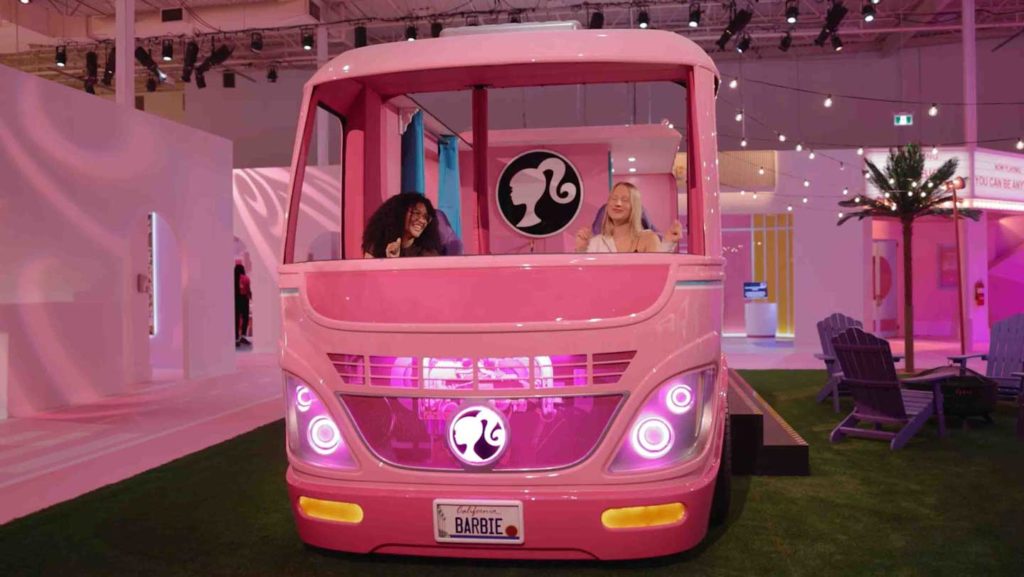 Featured in Barbie Film Locations, this image shows two young girls in the Barbie Dream Camper at Barbie World Museum on a fun vacation.