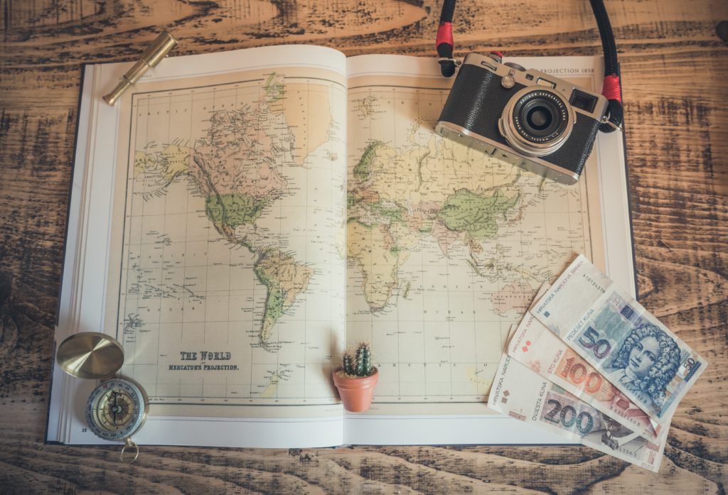 Featured in Affordable Vacation Destinations by Students Fare, this image shows a map spread out on a table.