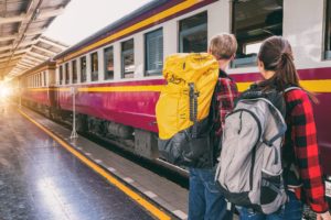 Featured in Student Friendly Train Travel by Students Fare, this image shows two people boarding a train on vacation.