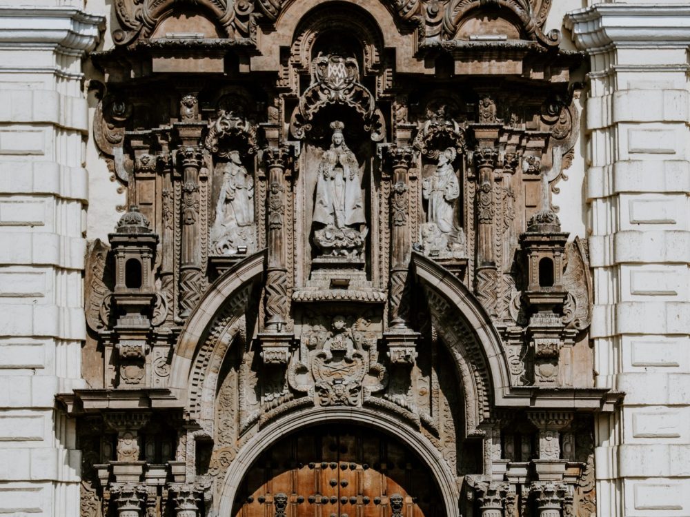 A student traveler at the front door of the Iglesia y Convento de San Francisco tour in Lima, Peru travel.