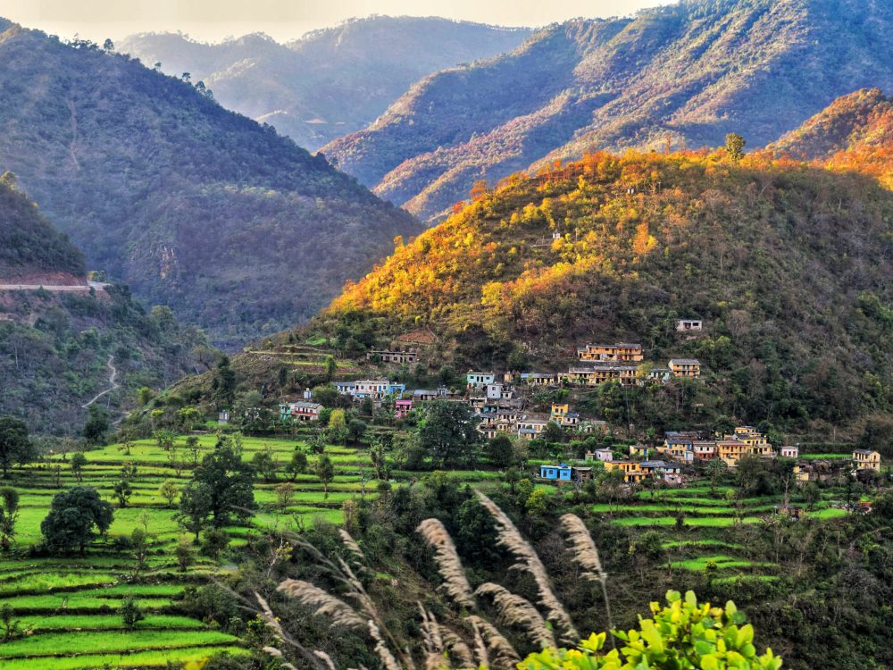 A scenic view of a tour of the land with the village, fields, and mountains in Rishikesh, Uttarakhand, India.
